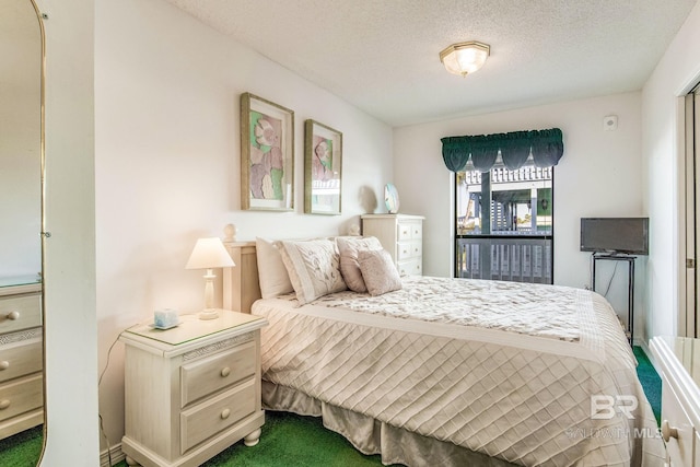 bedroom featuring carpet flooring and a textured ceiling