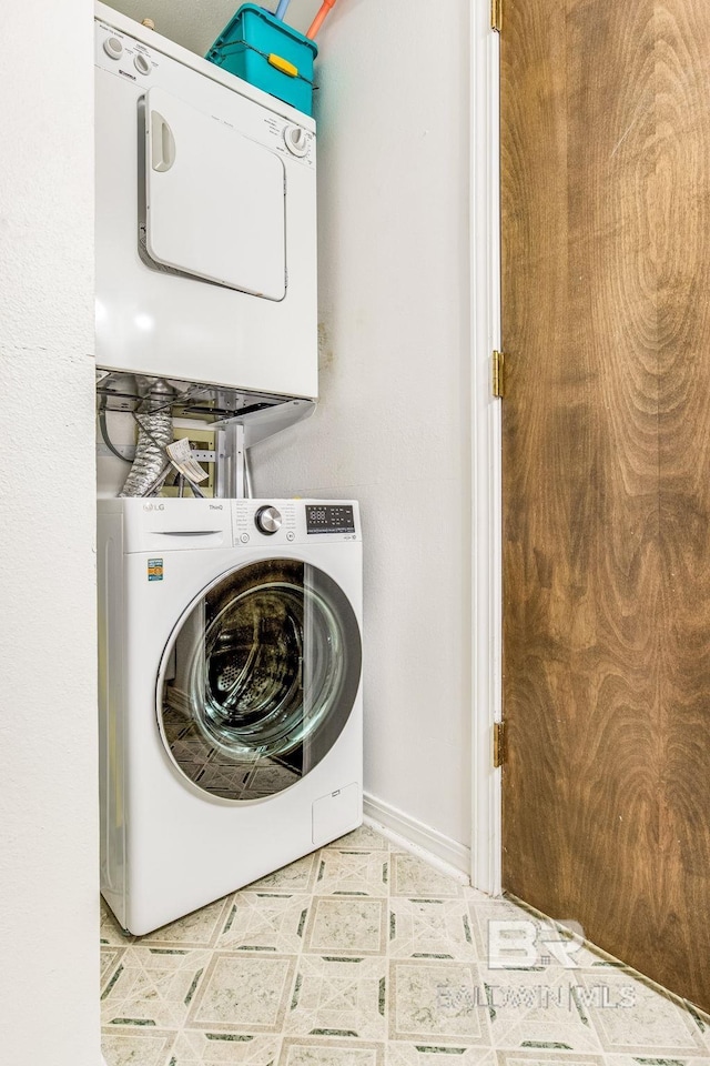 laundry area with stacked washer and clothes dryer