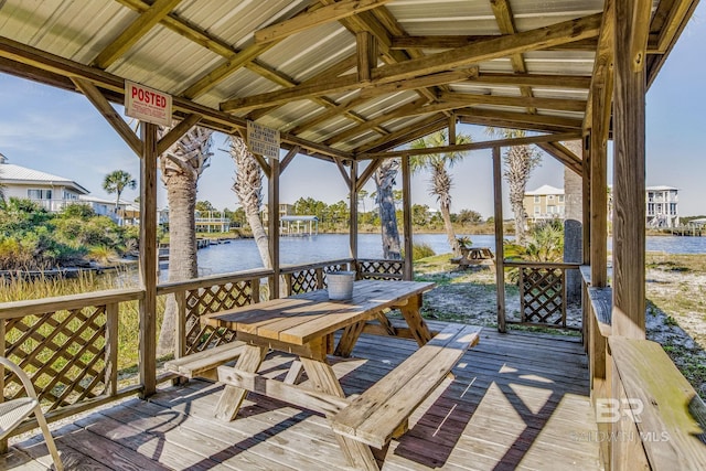 wooden terrace with a water view and a gazebo