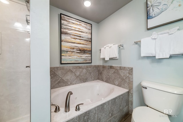 bathroom with toilet and a whirlpool tub