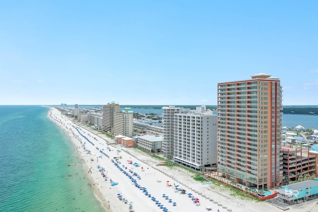 bird's eye view featuring a water view, a view of the beach, and a city view