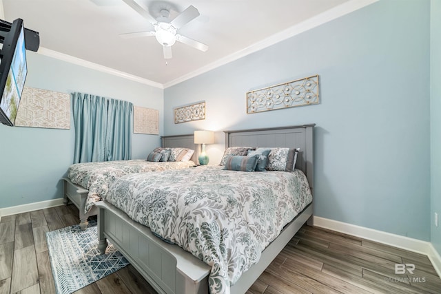 bedroom with baseboards, wood finished floors, and crown molding