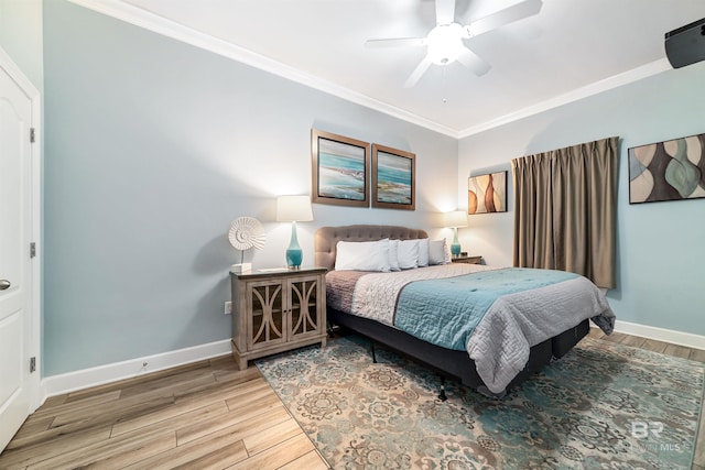 bedroom featuring ceiling fan, baseboards, crown molding, and wood finished floors