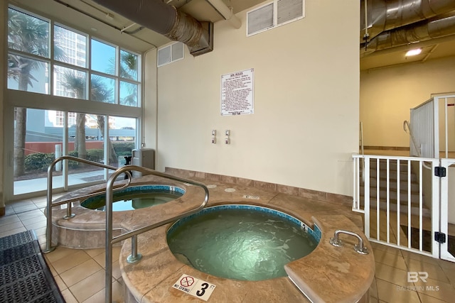 view of swimming pool with an indoor in ground hot tub