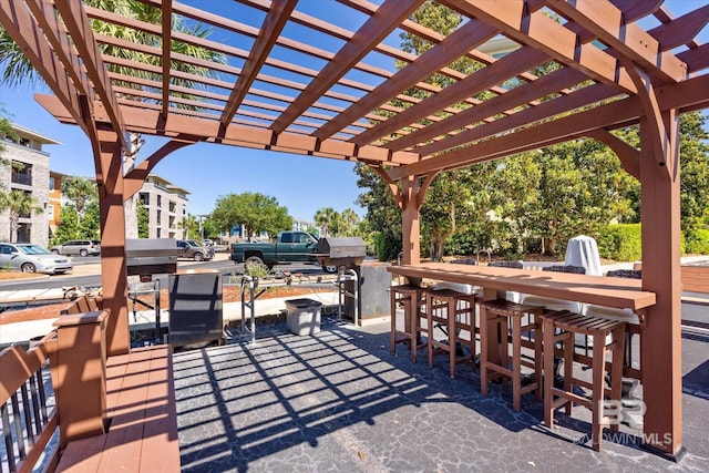 view of patio / terrace with a bar and a pergola