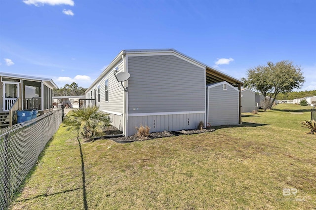 view of side of property featuring a yard and fence