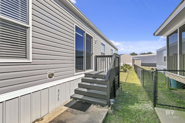 view of property exterior featuring fence and a yard