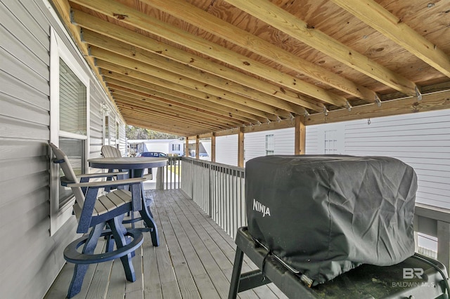 wooden terrace with a grill