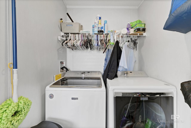 clothes washing area featuring laundry area and washer and clothes dryer