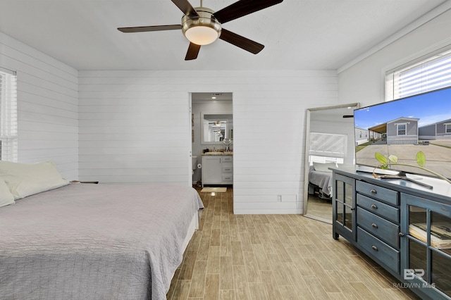 bedroom with light wood-style flooring and ceiling fan