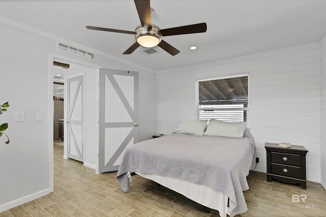 bedroom featuring wood tiled floor, visible vents, and baseboards