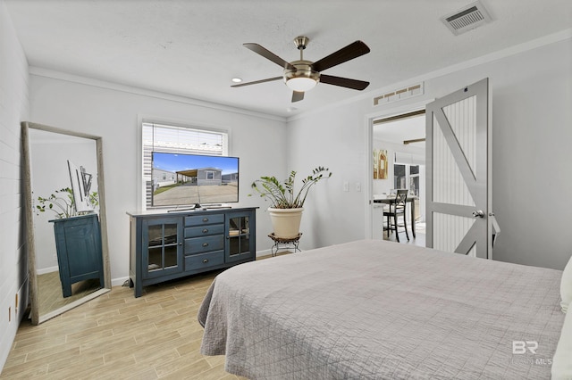 bedroom featuring light wood-type flooring, visible vents, and baseboards