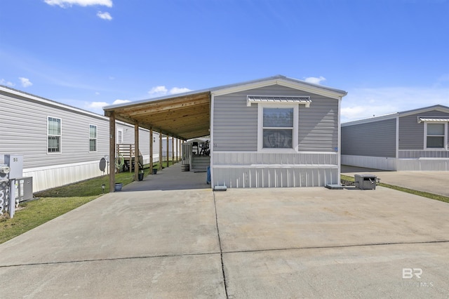 view of front of property featuring a carport and driveway