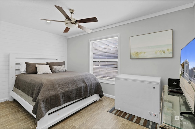 bedroom with fridge, baseboards, a ceiling fan, and wood finish floors