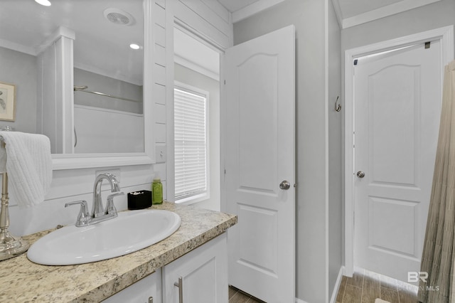 bathroom featuring visible vents, walk in shower, and vanity