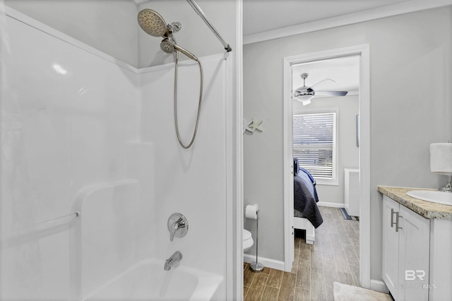 ensuite bathroom featuring bathtub / shower combination, toilet, ensuite bathroom, vanity, and wood finished floors