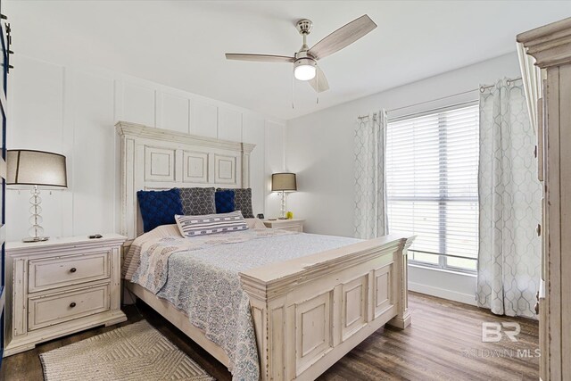 bedroom featuring multiple windows, hardwood / wood-style flooring, and ceiling fan