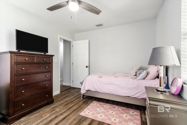 bedroom featuring ceiling fan and dark hardwood / wood-style floors