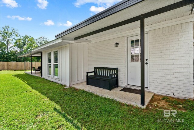 doorway to property featuring a yard