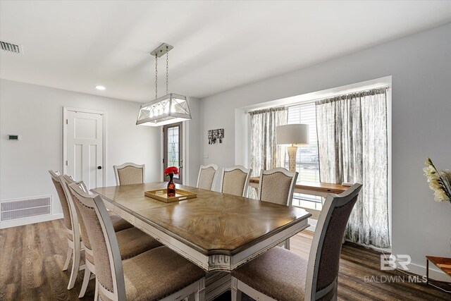 dining area with a wealth of natural light and dark hardwood / wood-style flooring