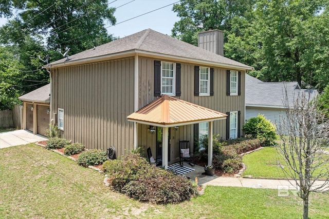 1116 Linlen Ave, Mobile, AL 36609 - view of front of house featuring a chimney, a front yard, board and batten siding, and a shingled roof