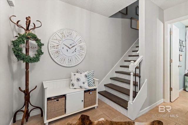 1116 Linlen Ave, Mobile, AL 36609 - stairs with tile patterned flooring, a textured ceiling, and baseboards