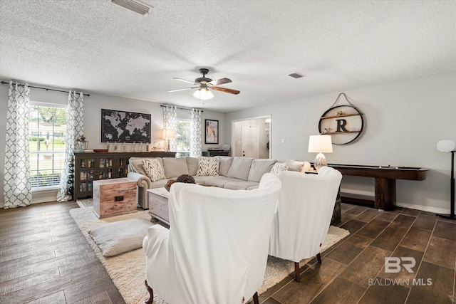 1116 Linlen Ave, Mobile, AL 36609 - living area featuring a ceiling fan, a textured ceiling, dark wood-style floors, and baseboards