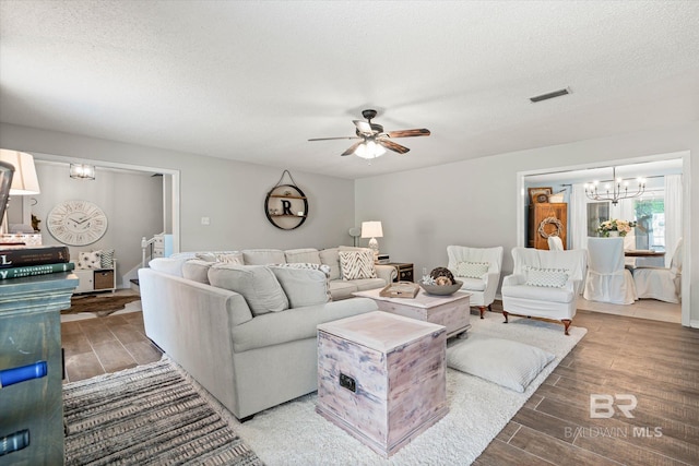 1116 Linlen Ave, Mobile, AL 36609 - living area featuring wood tiled floors, a chandelier, a ceiling fan, and a textured ceiling