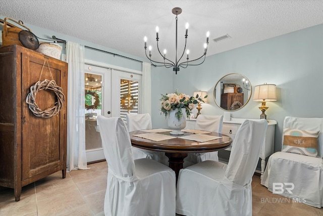 1116 Linlen Ave, Mobile, AL 36609 - dining room with a chandelier, a textured ceiling, and french doors