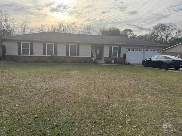 ranch-style home with an attached garage and a front yard