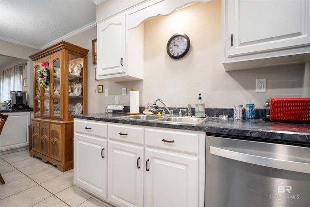 kitchen featuring stainless steel dishwasher, crown molding, dark countertops, and a sink