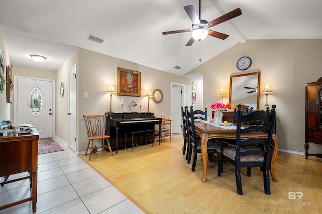 dining space with visible vents, vaulted ceiling with beams, light wood-type flooring, and baseboards