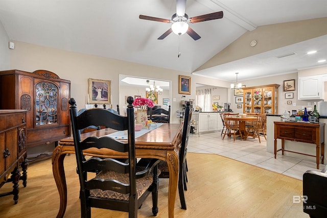 dining space featuring lofted ceiling with beams, light wood-style flooring, and ceiling fan with notable chandelier