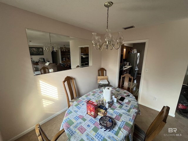 carpeted dining area featuring a notable chandelier