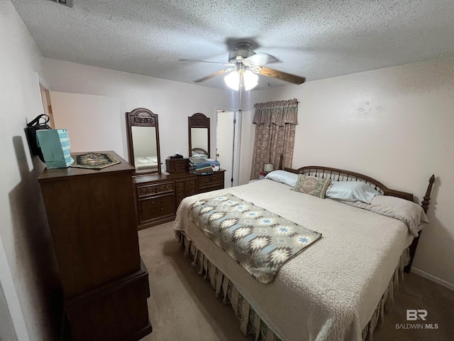 bedroom with carpet flooring, ceiling fan, and a textured ceiling