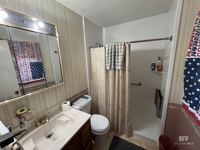 bathroom featuring vanity, tile patterned flooring, toilet, a textured ceiling, and walk in shower