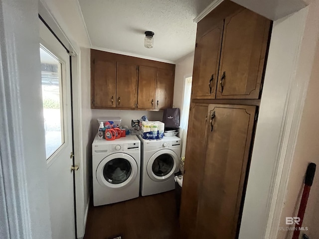 clothes washing area with washer and dryer, dark wood-type flooring, cabinets, and a textured ceiling