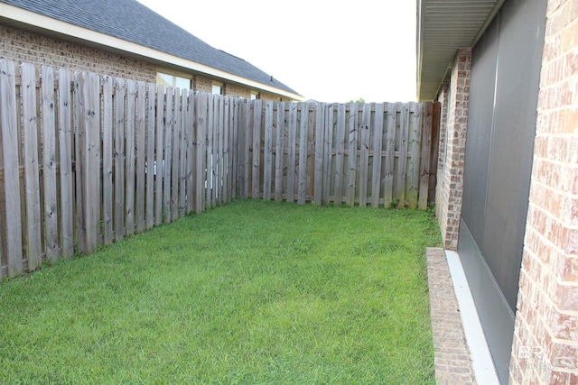 view of yard with a fenced backyard