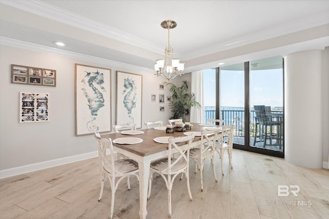 dining room with baseboards, light wood-type flooring, an inviting chandelier, and crown molding