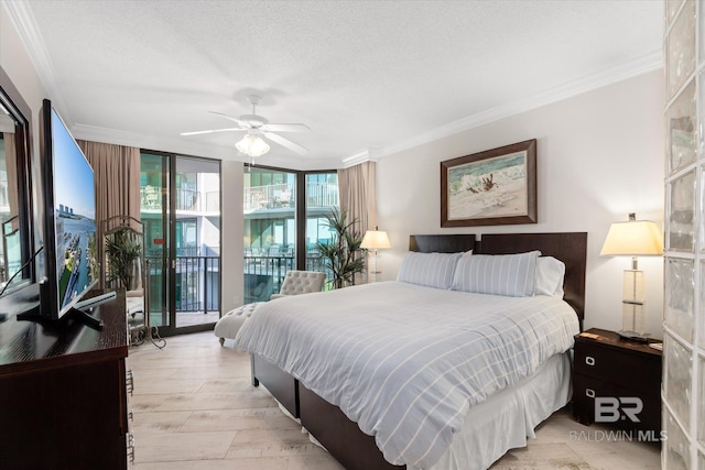 bedroom with a textured ceiling, light wood-style floors, access to outside, ornamental molding, and a wall of windows