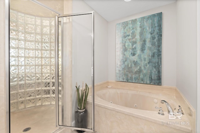 bathroom featuring a stall shower and a jetted tub