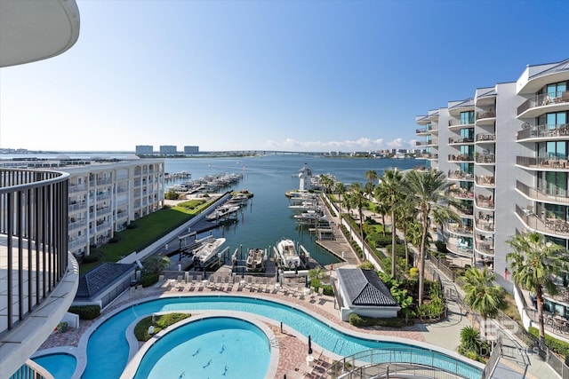 view of swimming pool featuring a water view, a view of city, and a community hot tub