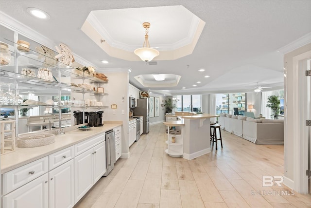 kitchen featuring a tray ceiling, open floor plan, white cabinetry, and open shelves