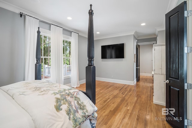 bedroom featuring ornamental molding and light hardwood / wood-style flooring