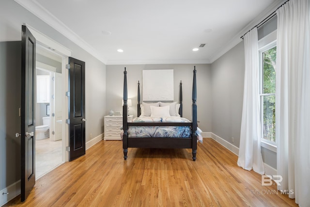 bedroom with ensuite bathroom, light hardwood / wood-style floors, and crown molding