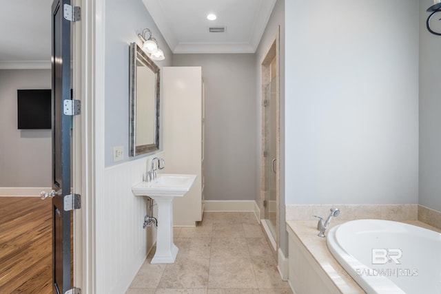 bathroom featuring ornamental molding, independent shower and bath, and tile flooring