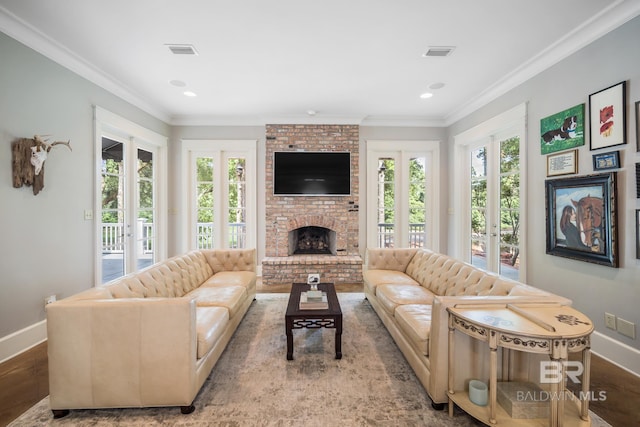 living room featuring a wealth of natural light, french doors, hardwood / wood-style flooring, and a fireplace