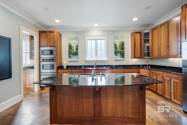 kitchen with a center island with sink, a kitchen bar, light tile flooring, and appliances with stainless steel finishes