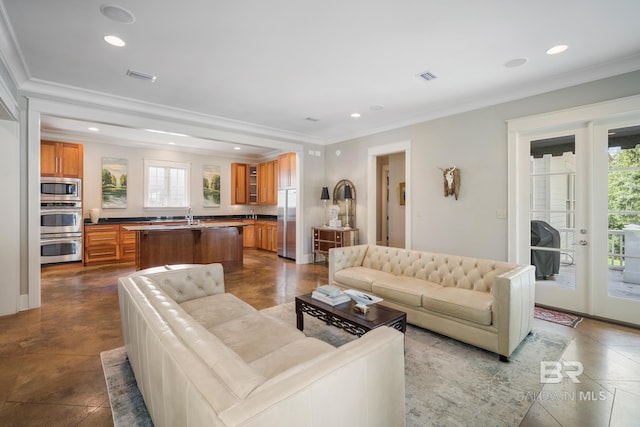 living room with tile flooring, ornamental molding, and sink