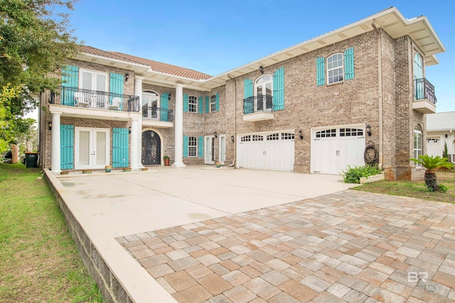 view of front of home with a balcony and a garage